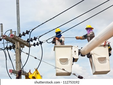 Electrical Utility Worker In A Bucket Fixes A Problem With A Power Line.