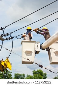 Electrical Utility Worker In A Bucket Fixes A Problem With A Power Line.