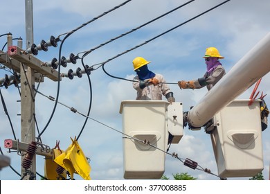 Electrical Utility Worker In A Bucket Fixes A Problem With A Power Line.