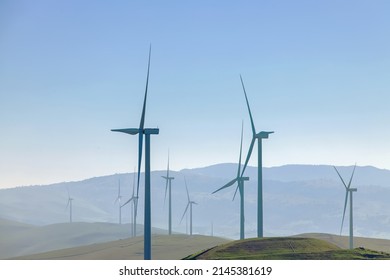 Electrical wind power mill over the blue sky. Alternative energy source. Ecological concept