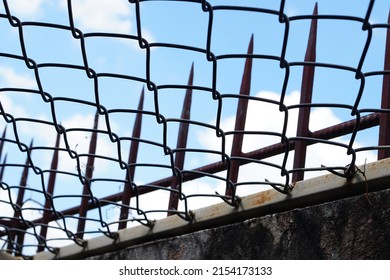 Electrical Wire And Spikes On Prison Walls