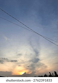 Electrical Wires Crossing a Dramatic Sunset Sky
