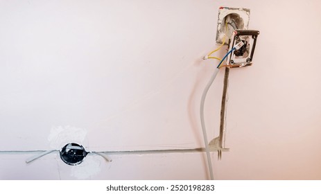 Electrical wiring installation process captured inside a home under renovation demonstrates resolving household electrical issues
