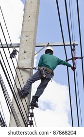 An Electrical Worker, On Concrete Pole, Performs Transmission Lines Repairing