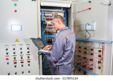 Electrician Builder Engineer Screwing And  Testing Equipment In Fuse Box (industrial Machine) And Repairing Of Electricity Power Station 