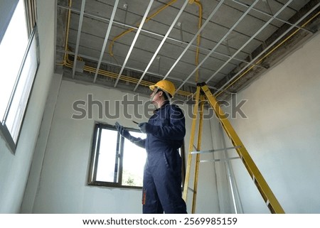 Electrician checking the current for the installation of electrical system in the house. Concept of electrical installation in the house and safety in construction.