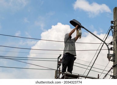 Electrician checking lighting to the LED street lamp post, Technician and maintenance service concepts