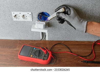 An Electrician Checks The Voltage On The Wire Connected To The Underfloor Heating Regulator With An Indicator. Electrical Safety. Checking The Absence Of Voltage.