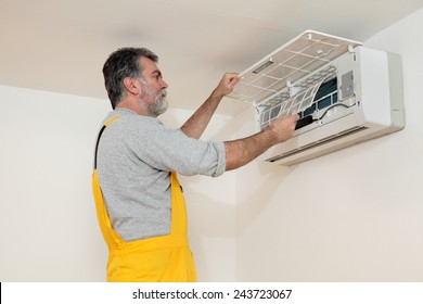 Electrician Cleaning Filter Of Air Condition Device In A Room