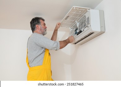 Electrician Cleaning Filter Of Air Condition Device In A Room