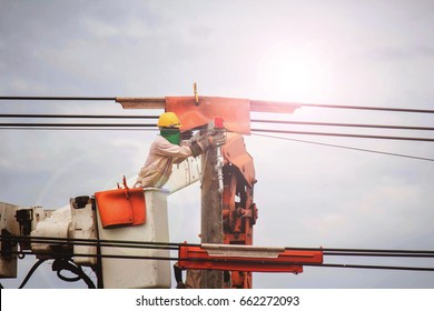 Electrician Climbing Pole