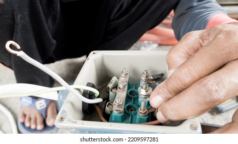 An Electrician Connecting The Cable Terminals Power Induction  Three Phase Motor.