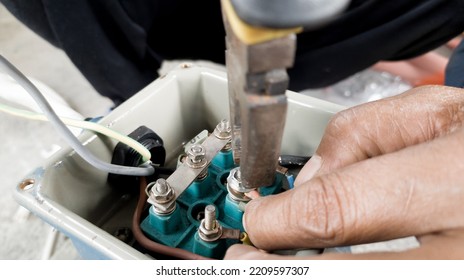 An Electrician Connecting The Cable Terminals Power Induction  Three Phase Motor.