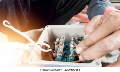 An Electrician Connecting The Cable Terminals Power Induction  Three Phase Motor.