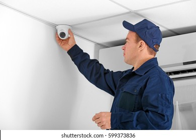 Electrician Connecting CCTV Camera In Office