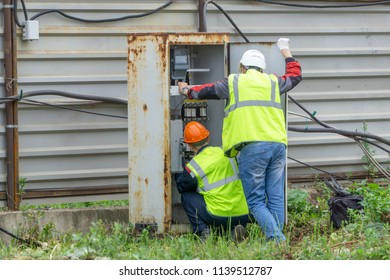 The electrician at the construction site connects the electrical panel - Shutterstock ID 1139512787