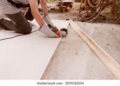 An electrician cuts the concrete slab on the floor. at the construction site with expertise