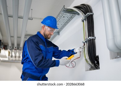 Electrician Doing Cable Installation And Maintenance In Office