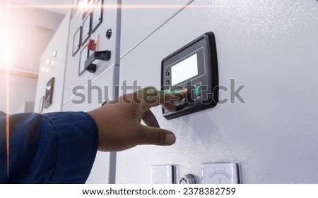 The electrician engineer check and control interlock generator system on the panel power plant.Check and  maintenance  auto control generator switch gear.with shiny light.