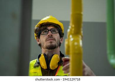 Electrician engineer checking technical data of heating system equipment and piping air compressor system at manufacturing factory. - Powered by Shutterstock