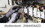 Electrician engineer tests electrical installations and wires on relay protection system. Adjustment of scheme of automation and control of electrical equipment.