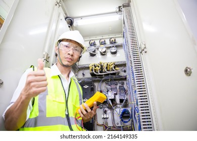 Electrician engineer work at Relay protection system. Bay control unit. Medium voltage switchgear. 