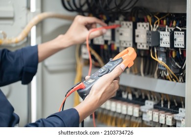 Electrician Engineer Work Tester Measuring Voltage And Current Of Power Electric Line In Electrical Cabinet Control , Concept Check The Operation Of The Electrical System .