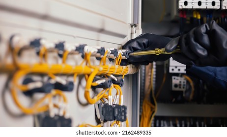 Electrician engineer work tester measuring voltage and current of power electric line in electrical cabinet control. and wires on relay protection system. Bay control unit. Medium voltage switchgear.