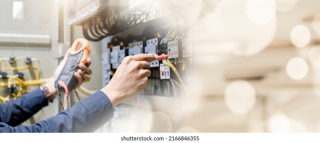 Electrician engineer work  tester measuring  voltage and current of power electric line in electrical cabinet control. - Shutterstock ID 2166846355