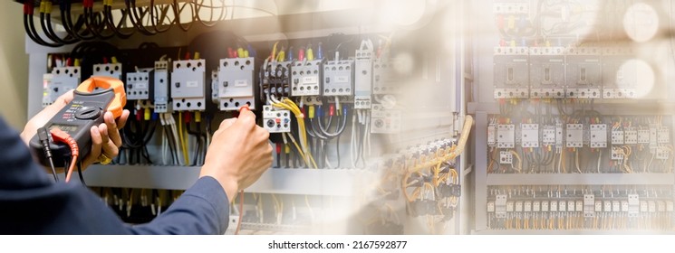 Electrician engineer work  tester measuring  voltage and current of power electric line in electrical cabinet control. - Shutterstock ID 2167592877