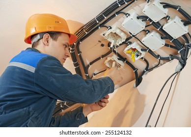 electrician engineer works with cables at distribution boxes in electric network