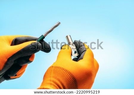  electrician holding cable and cable lug. connecting electrical cables. 