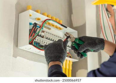 An electrician inspects the electrical wiring in an new home, upgrading the system to meet current safety standards.