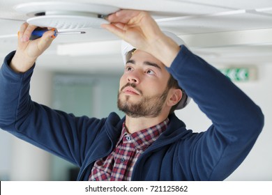 Electrician Installing Ceiling Light