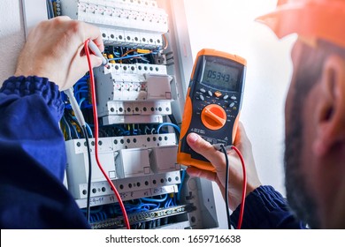 Elektriker installere elektriske kabel ledninger og sikringskontakt boks. Multimeter i hænderne på elektrikere detaljer.