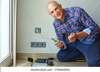 Electrician Installing Socket In House