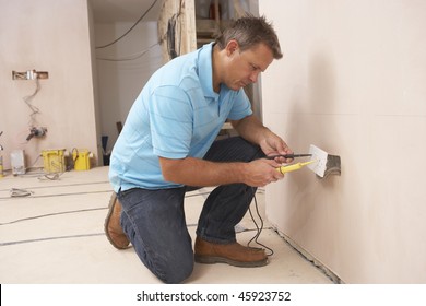 Electrician Installing Wall Socket