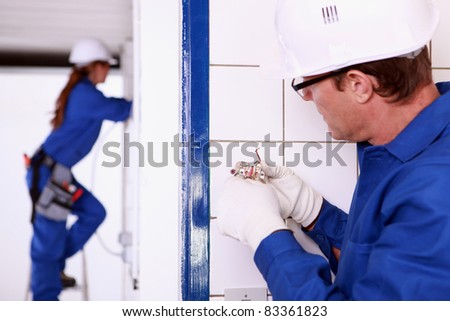 Electrician installing a wall socket