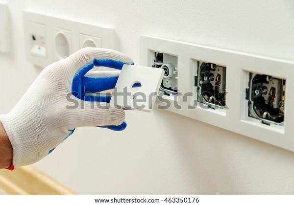 Electrician Installs Decorative Frame On Electric Stock Photo