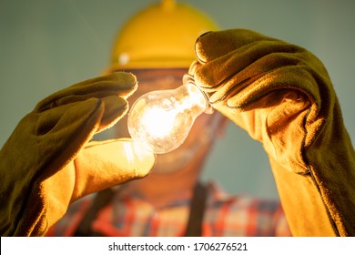 Electrician with light bulbs,Electrician Fixing the Light Inside Remodeled at home.