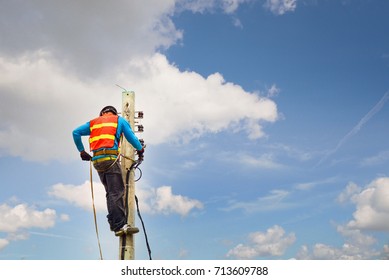 Electrician lineman repairing work on electric post power pole