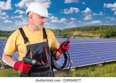 Electrician Man In Front Of Solar Panels. Power Plant Worker. Solar Panel Installer. Energy Company Employee. Solar Power Plant In Picturesque Location. Installation Of Sunlight Traps