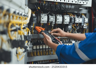 Electrician measurements with multimeter testing current electric in control panel, safety concept . - Powered by Shutterstock