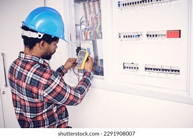 Electrician multimeter, electric switch box and man test cable system, wiring or measure voltage power supply. Quality control inspection, African repair person and technician electricity maintenance