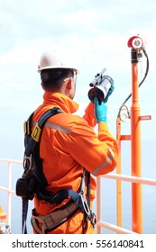 Electrician Operator With Safety Harness Inspect And Checking Fire And Gas Detection. Fire And Gas Detection Monitoring System In Hazardous Area In Oil And Gas Central Processing Platform.