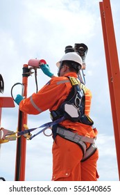 Electrician Operator With Safety Harness Inspect And Checking Fire And Gas Detection. Fire And Gas Detection Monitoring System In Hazardous Area In Oil And Gas Central Processing Platform.