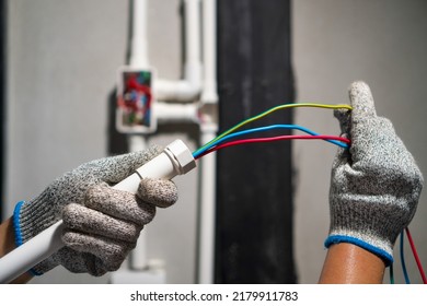 Electrician Pulling Wire Into PVC Conduit