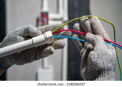 Electrician Pulling Wire Into PVC Conduit