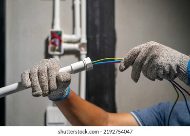 Electrician Pulling Wire Into PVC Conduit