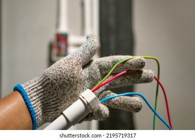 Electrician Pulling Wire Into PVC Conduit